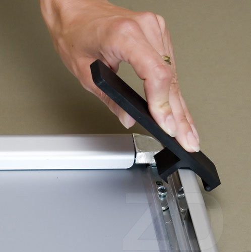 Opening of Poster Frame - Security with an opener tool. 